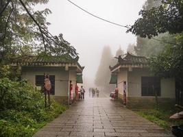 zhangjiajie.China - 14 October 2018. Unacquainted Tourists Walking on tianzi mountain in Zhangjiajie National Forest Park in Wulingyuan District Zhangjiajie City China in the Foggy day. photo