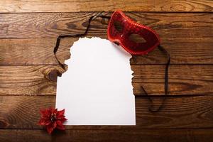 Christmas card and New Year accessories on brown wooden table. Top view. Copy space and place for text. photo