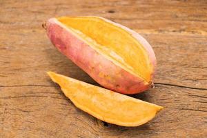 fresh potato on wooden table photo