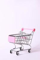 Metalic supermarket car, pink, isolate photo