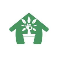 Ecological garden home vector logo design. Hand tree with flower pot icon design.