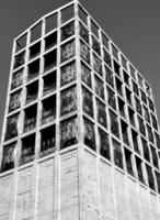 Vertical grayscale of a modern building with unique window designs