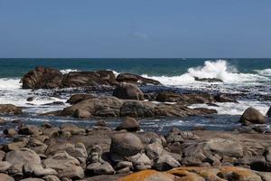 Seascape with rocks in the foreground photo