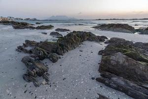 Seascape with rocks in the foreground photo