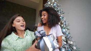 Girl friends wearing dresses spend time at home, christmas time video