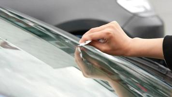 Windshield getting cleaned up with spray product video