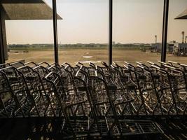 Luggage Cart beside the window in don muang internation airport bangkok City Thailand photo