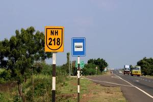 Vijayapura, Karnataka, November 26, 2021 - NH 218 and Bus Stop Sign Board on National Highway 218. photo