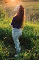 Portrait of a beautiful young woman on meadow photo