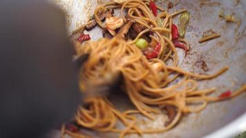 Noodles being cooked in a large wok video