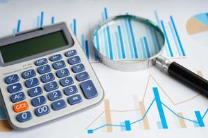 Calculator on chart and graph spreadsheet paper. Finance development, Banking Account, Statistics, Investment Analytic research data economy, Stock exchange trading, Business company concept. photo