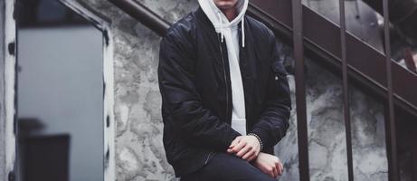 trendy young man in black jacket photo