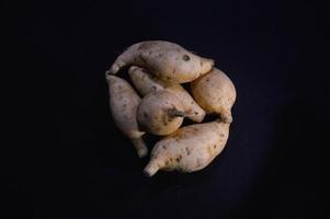 sweet potato on a plate on a black background photo