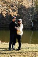 Couple in pound at early spring park. photo