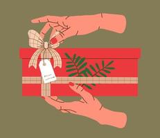 Hands holding Christmas gift in red kraft paper with tag and branches. Present box in craft wrapping paper with bow and branches. Colored flat vector illustration isolated on background.