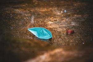 Origami paper boat in the rain photo