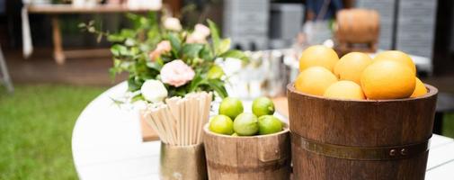 Lemon orange drinks on bar table outside garden. photo