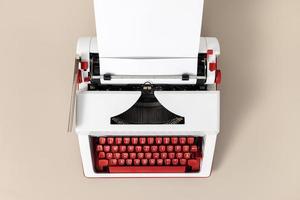 Top view of a retro typewriter with blank white paper. Creative writing process concept photo