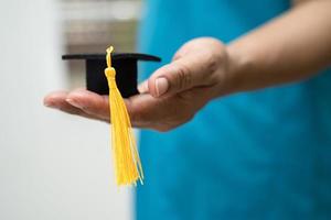 Asian doctor study learn with graduation gap hat in hospital ward, clever bright genius education medicine concept. photo