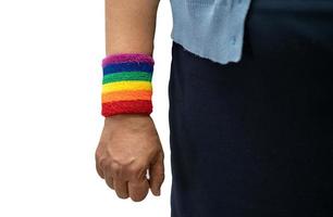 Asian lady wearing rainbow flag wristbands isolated on white background with clipping path, symbol of LGBT social of gay, lesbian, bisexual, human rights. photo