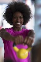 woman working out in a crossfit gym with dumbbells photo