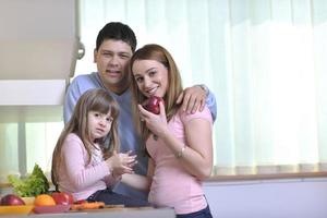 happy young family in kitchen photo