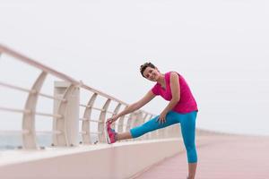 woman stretching and warming up on the promenade photo