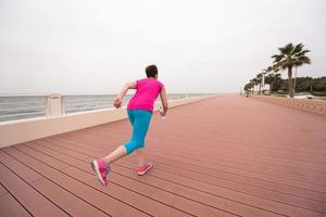 woman busy running on the promenade photo