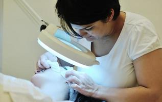 woman with facial mask in cosmetic studio photo