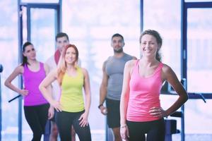 Group of people exercising at the gym photo