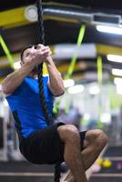 man doing rope climbing photo