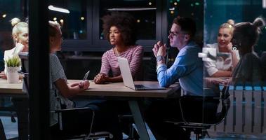 Multiethnic startup business team in night office photo