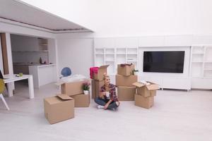 woman with many cardboard boxes sitting on floor photo