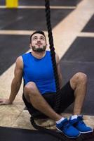 man relaxing before rope climbing photo