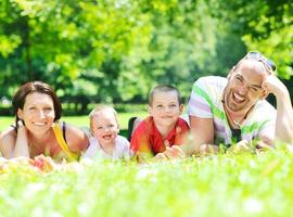 happy young couple with their children have fun at park photo