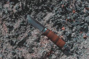 cuchillo de caza sobre una superficie de carbón foto