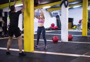 young athletes couple working out with medical ball photo