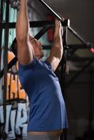 man doing pull ups photo