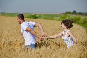 happy couple in wheat field photo