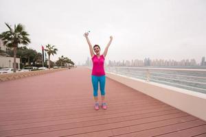 young woman celebrating a successful training run photo