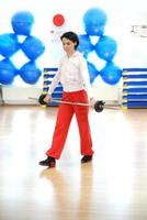 .a young woman weightlifting at gym photo