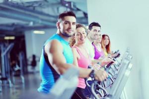 Group of people running on treadmills photo