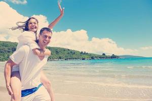 happy couple have fun on the beach photo