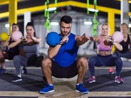 athletes doing exercises with kettlebells photo