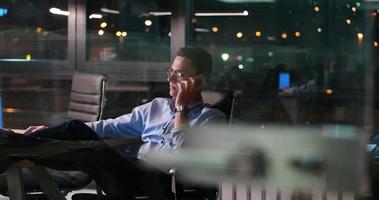 businessman sitting with legs on desk at office photo