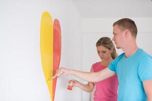 couple are painting a heart on the wall photo