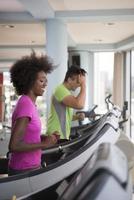 people exercisinng a cardio on treadmill in gym photo