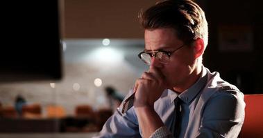 man working on computer in dark office photo