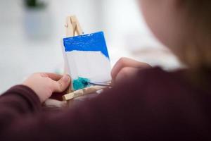 little girl painting on canvas photo