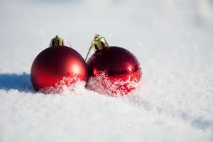 red christmas ball in fresh snow photo